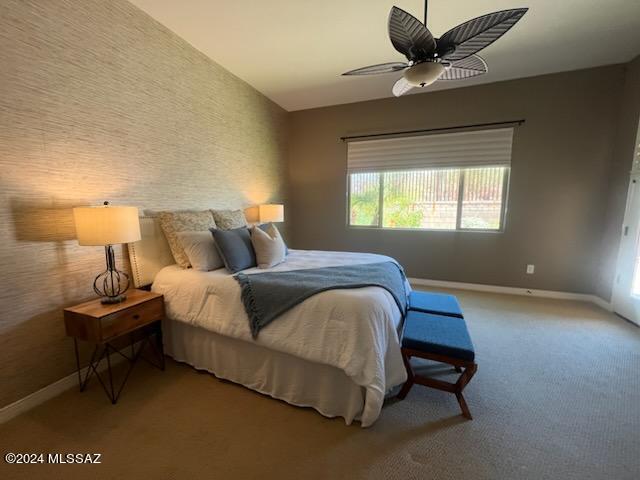 carpeted bedroom featuring ceiling fan and lofted ceiling