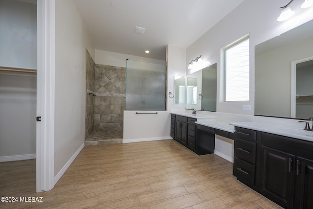 bathroom featuring vanity and tiled shower