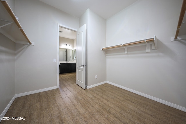 spacious closet with light hardwood / wood-style floors