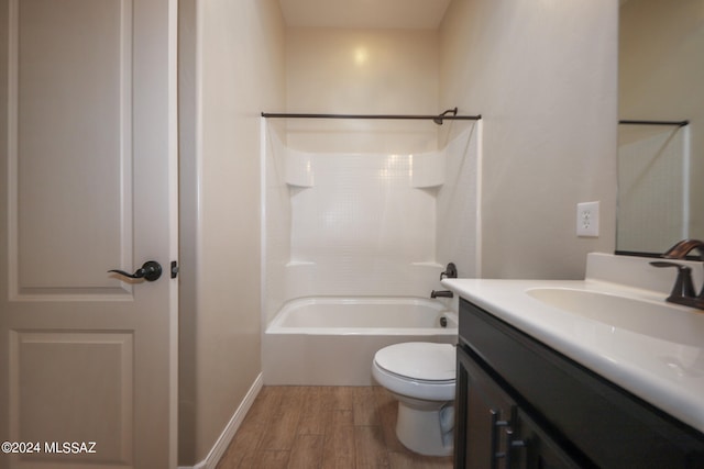 full bathroom featuring wood-type flooring, toilet, vanity, and shower / tub combination