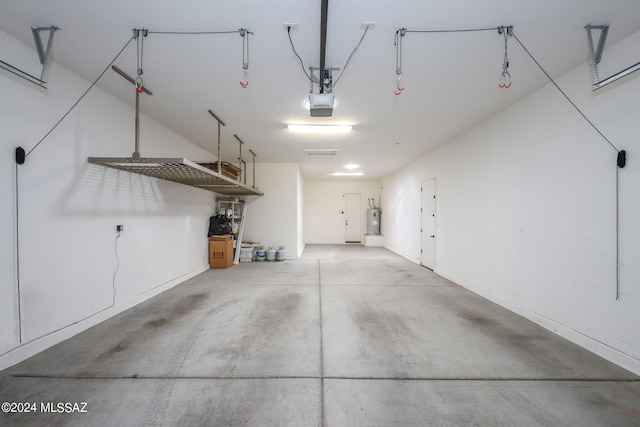 garage with a garage door opener and water heater