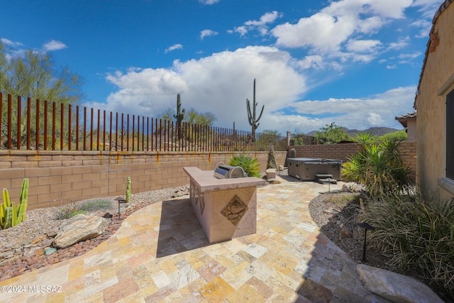 view of patio with a hot tub