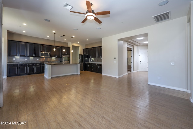 unfurnished living room featuring hardwood / wood-style flooring and ceiling fan