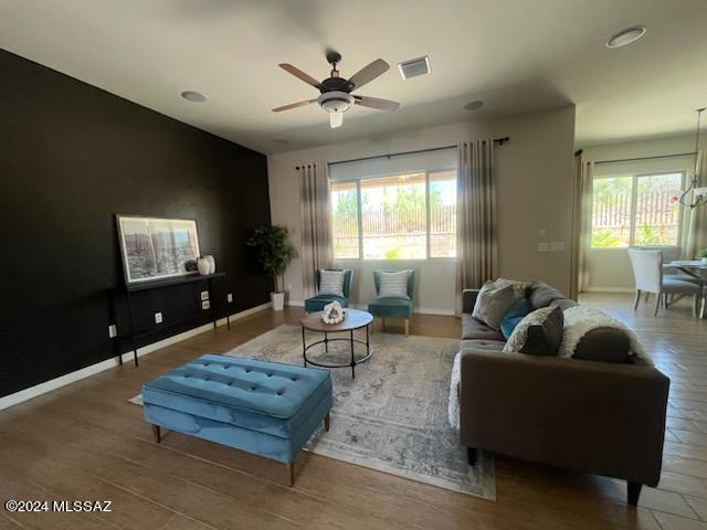 living room featuring hardwood / wood-style floors, ceiling fan, and plenty of natural light