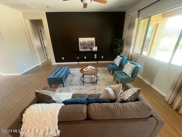 living room with wood-type flooring and ceiling fan