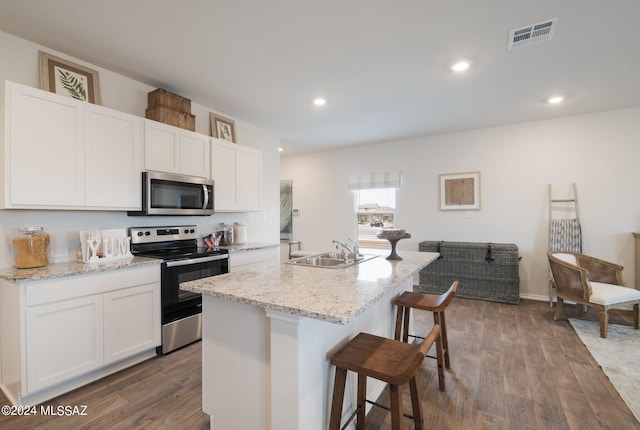 kitchen featuring dark hardwood / wood-style floors, stainless steel appliances, sink, and white cabinets