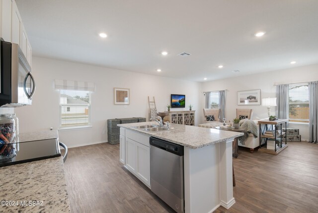 kitchen with dark hardwood / wood-style floors, white cabinetry, a healthy amount of sunlight, and appliances with stainless steel finishes