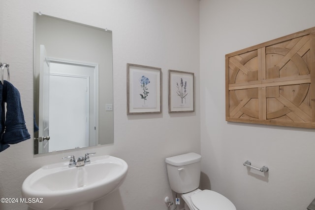 bathroom featuring sink and toilet