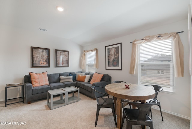 carpeted living room featuring vaulted ceiling