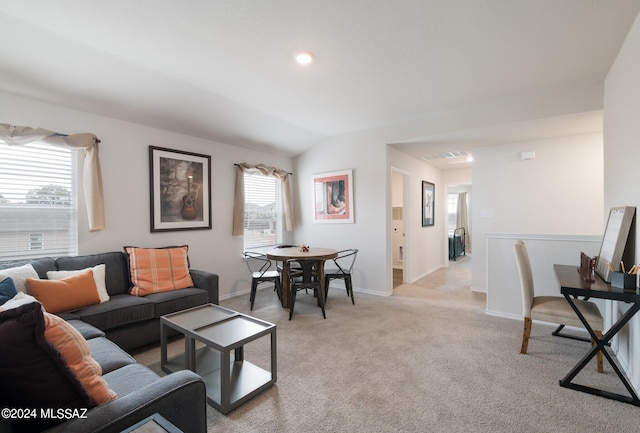 carpeted living room with lofted ceiling