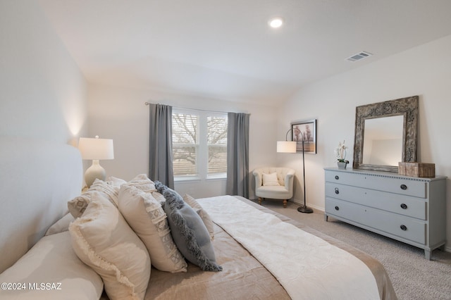 carpeted bedroom with lofted ceiling