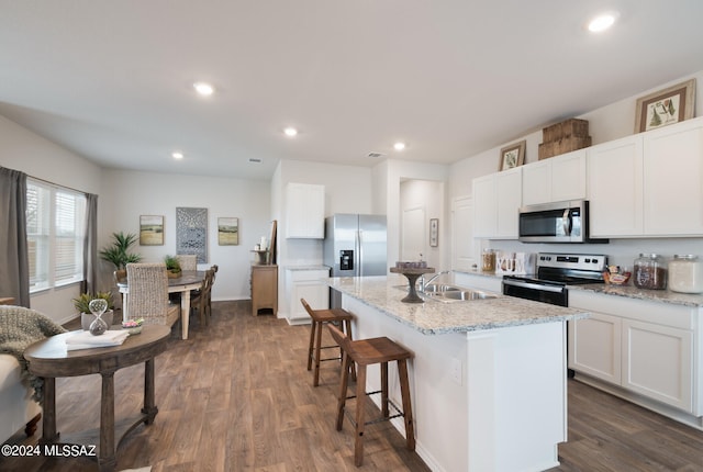 kitchen featuring sink, appliances with stainless steel finishes, hardwood / wood-style flooring, and white cabinets