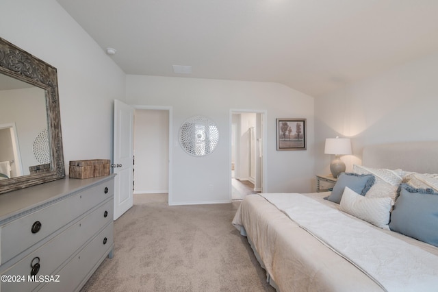 bedroom featuring light carpet and lofted ceiling