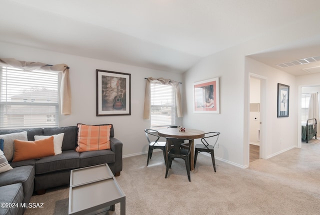 living room with light carpet and vaulted ceiling