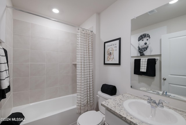 full bathroom featuring vanity, shower / bathtub combination with curtain, and toilet