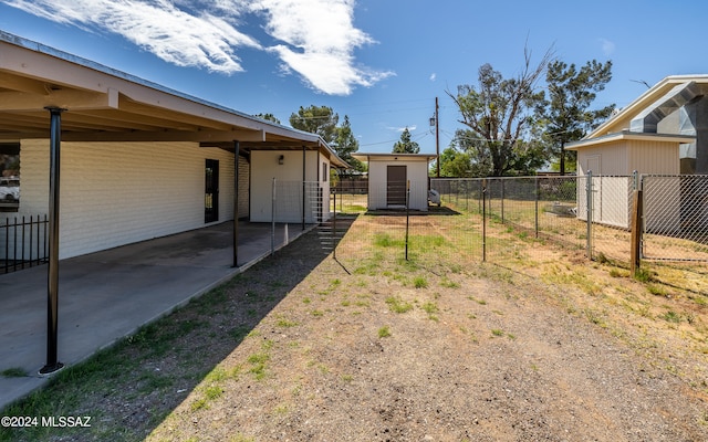 view of yard featuring a patio area and a storage unit