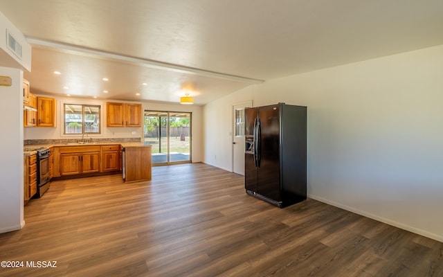 kitchen featuring range, dark hardwood / wood-style flooring, sink, and black fridge