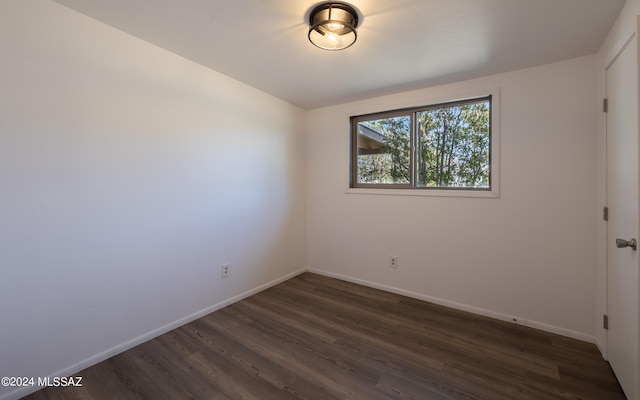 spare room with dark hardwood / wood-style floors