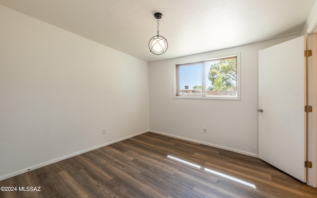 empty room with dark hardwood / wood-style flooring