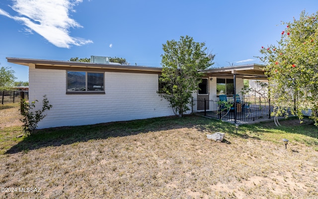 rear view of property with a yard