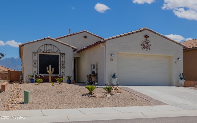 mediterranean / spanish-style home with a garage