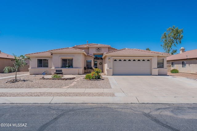 mediterranean / spanish-style home with a garage