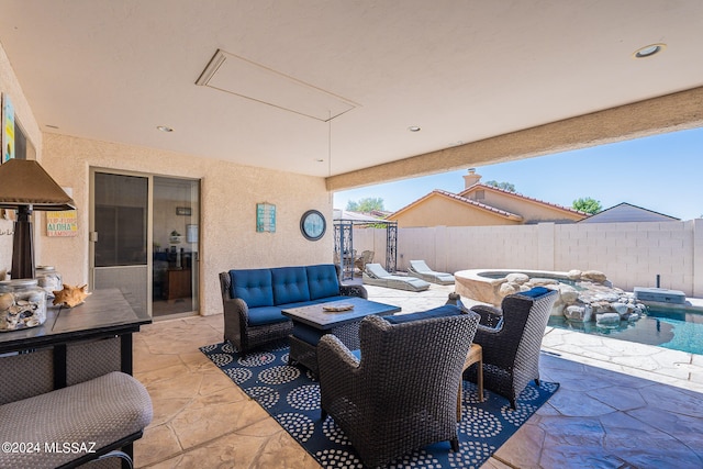 view of patio with an outdoor living space with a fire pit and a fenced in pool