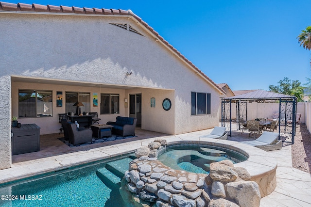 view of swimming pool with a patio area, a gazebo, and an in ground hot tub