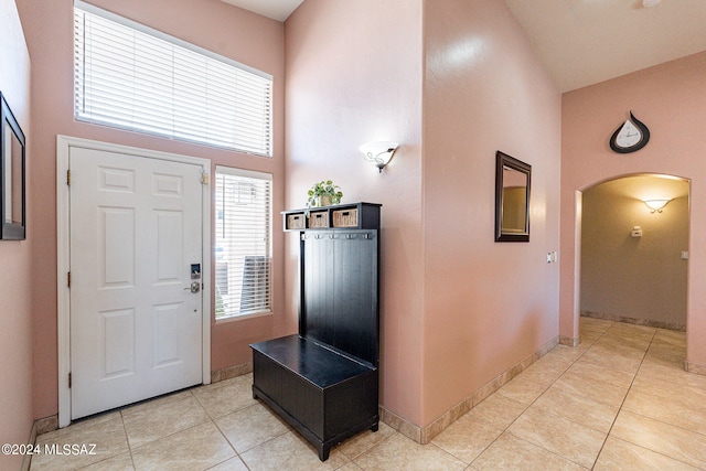 tiled entryway with a high ceiling