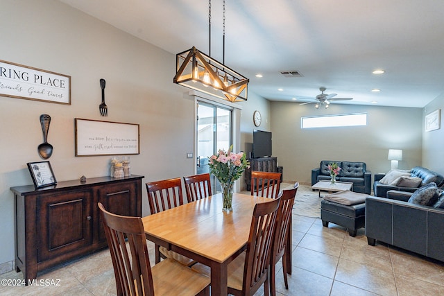 tiled dining area featuring vaulted ceiling, ceiling fan, and a healthy amount of sunlight