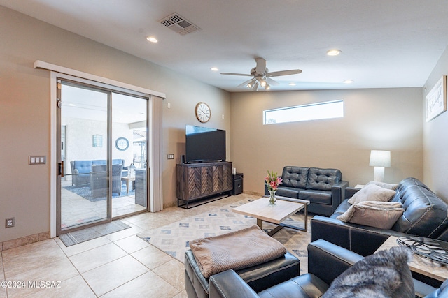 living room with vaulted ceiling, ceiling fan, and light tile floors