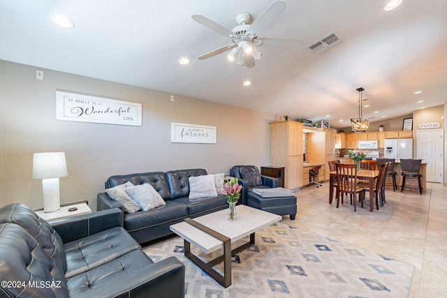 living room featuring ceiling fan, vaulted ceiling, and light tile floors