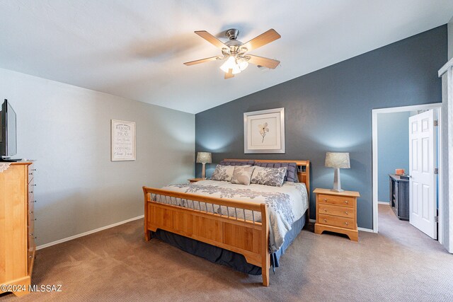 carpeted bedroom with ceiling fan and vaulted ceiling