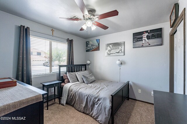 carpeted bedroom with a closet and ceiling fan