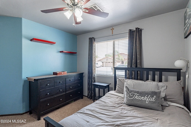 bedroom with ceiling fan and light carpet