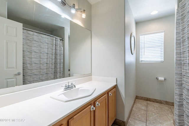 bathroom featuring vanity with extensive cabinet space and tile flooring