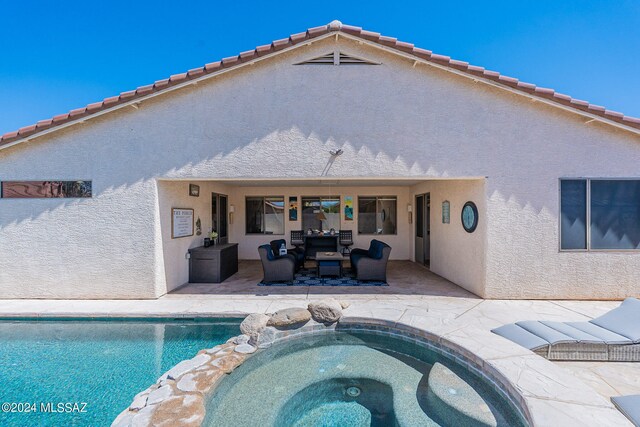 view of pool featuring a patio area, an outdoor hangout area, and an in ground hot tub