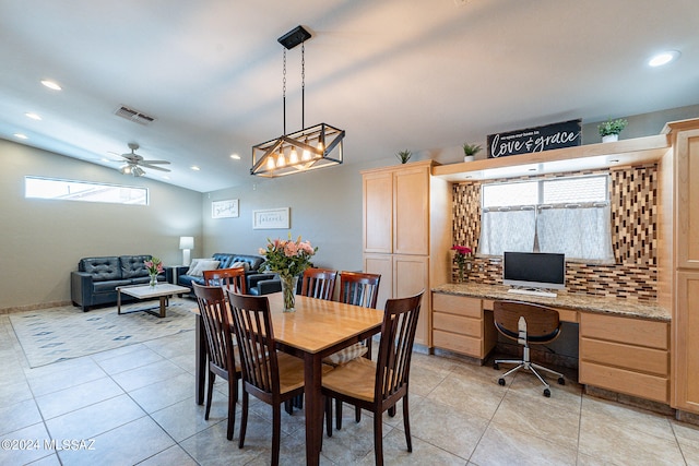 tiled dining area with lofted ceiling and ceiling fan