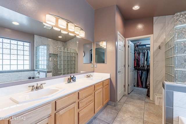 bathroom with tile flooring, separate shower and tub, and dual vanity