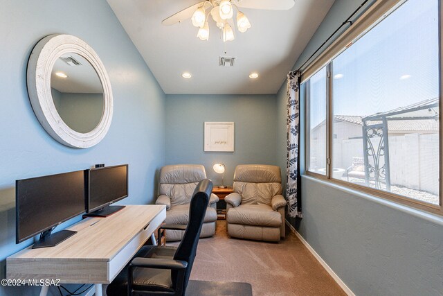 carpeted home office with plenty of natural light and ceiling fan