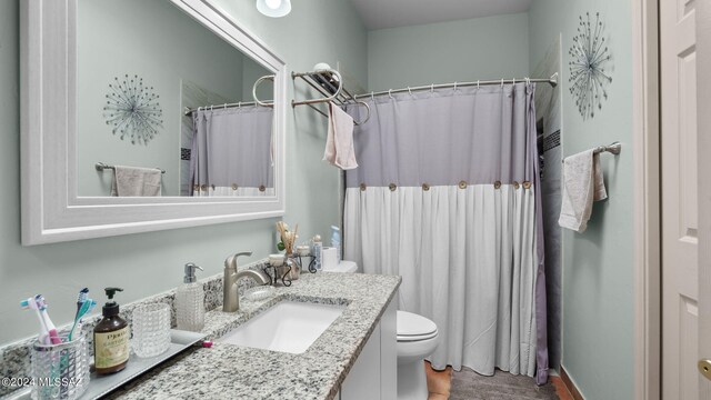 bathroom with oversized vanity, hardwood / wood-style flooring, and toilet