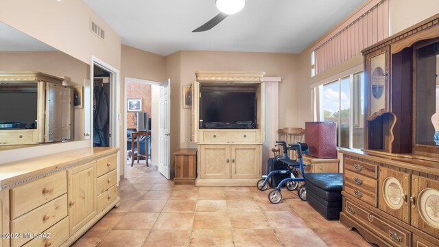 interior space featuring ceiling fan and light tile floors