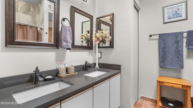 bathroom with tile flooring and dual vanity