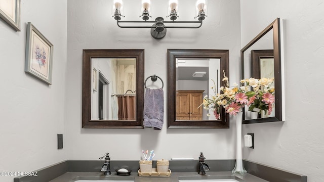 bathroom with sink and an inviting chandelier