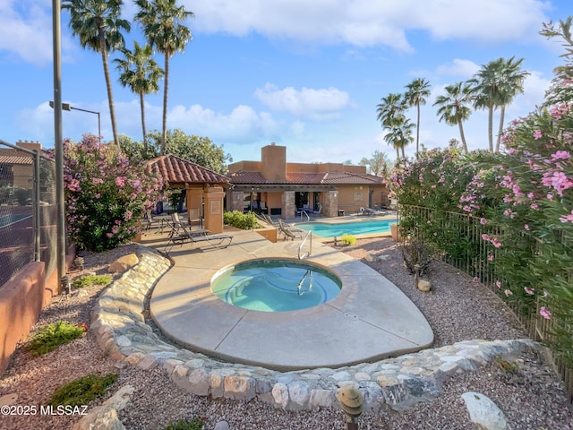 view of pool with a gazebo, a community hot tub, and a patio area