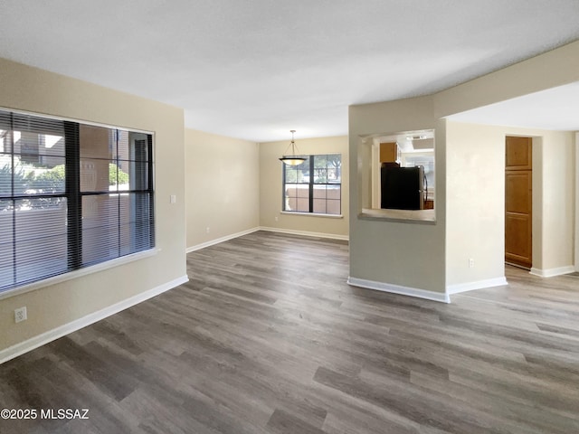 unfurnished living room with dark wood-type flooring