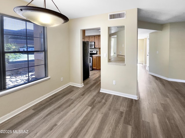 unfurnished dining area with hardwood / wood-style flooring