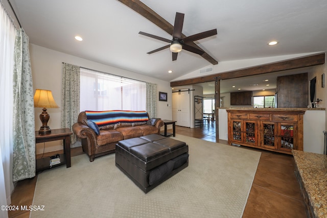 tiled living room with lofted ceiling with beams, ceiling fan, and a barn door