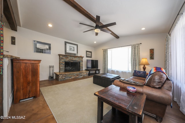 living room featuring ceiling fan, vaulted ceiling with beams, and a stone fireplace