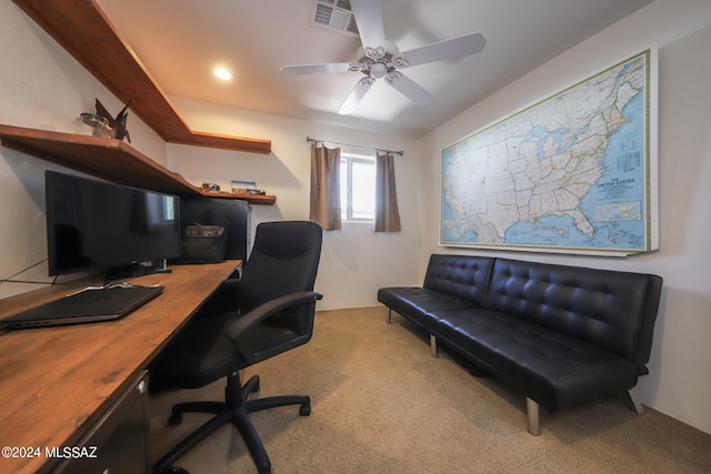 carpeted office space with ceiling fan